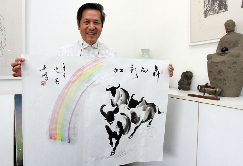 吴亚鸿与其2021年牛年作品《犇向彩虹》合摄。