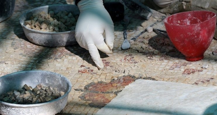 A worker restores a mosaic floor at an ancient church in the small Jordanian town of Rihab. AFP