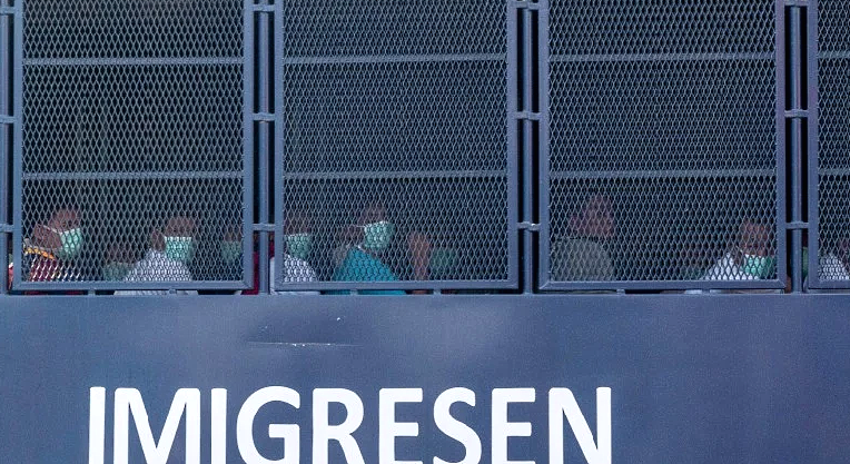 An immigration truck believed to be carrying Myanmar migrants back to their homeland, is seen heading towards Lumut naval base. AFP