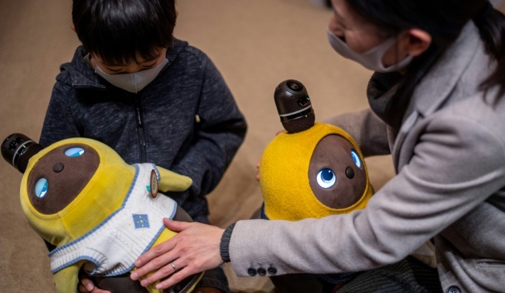 People can visit the Lovot Cafe near Tokyo to interact with the bots, which have big round eyes and penguin-like wings that flutter. AFP