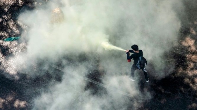 A protester uses a fire extinguisher as security forces crack down on demonstrations against the military coup in Yangon. AFP A protester uses a fire extinguisher as security forces crack down on demonstrations against the military coup in Yangon. AFP