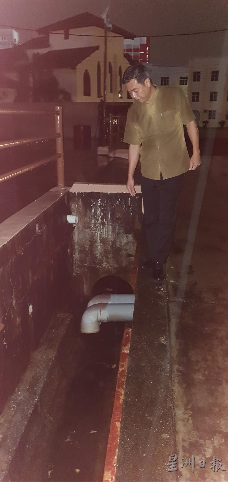  怡力州议员郑国球巡视选区内的排水情况。