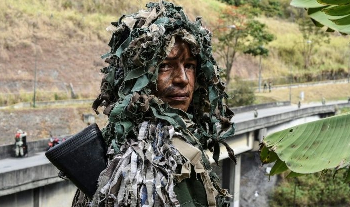 Ismaira Figueroa, a sniper for the Bolivarian militia, poses while taking part in military exercises for the 