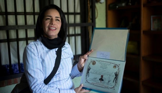 Ismaira Figuero keeps a folder with her diplomas, including a sheet of paper with six holes in it that confirmed her graduation as an 