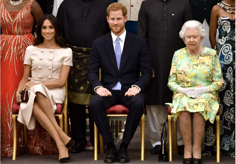 (From left) Meghan, Prince Harry and Queen Elizabeth II. AFP