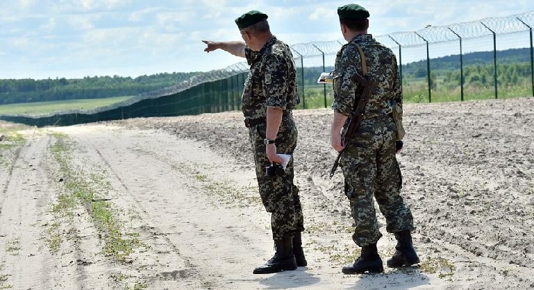 Ukrainian border guards patrol along the Senkivka border post. AFP