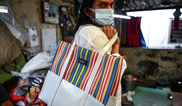 Founder of 'Chamar Studio', Sudheer Rajbhar shows his bags made from recycled rubber. AFP