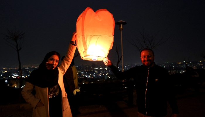 Iranians release a lantern during the Wednesday Fire feast in Tehran. AFP