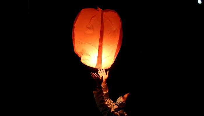 An Iranian releases a lantern during the Wednesday Fire feast in Tehran. AFP