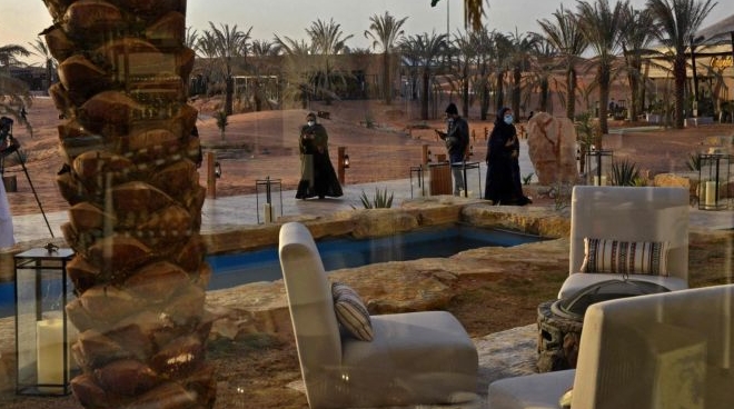 Well-heeled Saudis frolic in an artificial oasis built on salmon-colored dunes. AFP