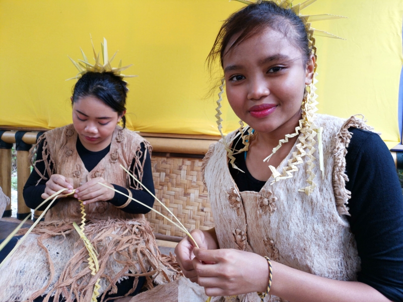 原住民正用尼帕棕榈树叶子制作手作物。图库图

