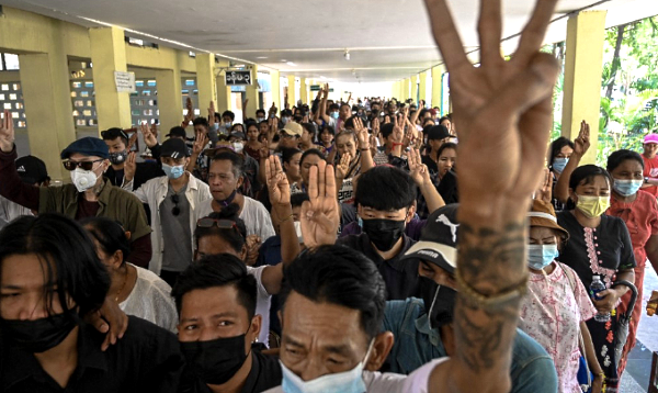 Mourners hold up the three-finger salute during the funeral of teenage protester Aung Kaung Htet in Yangon a day after he was killed by security forces at a demonstration. AFP