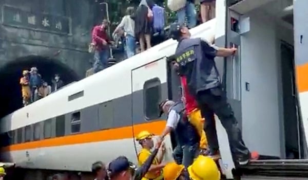 Handout picture released by Taiwan Red Cross shows rescue teams at the site where a train derailed inside a tunnel in the mountains of Hualien. AFP