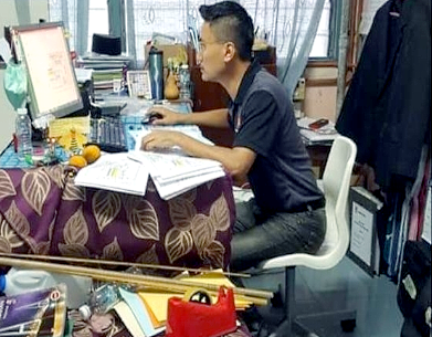 Wong Yong Geng studies Chinese at home to prepare himself for SPM Chinese paper after work.