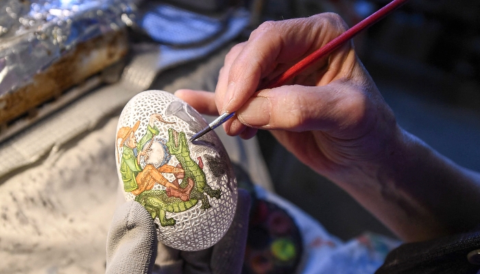 Tunde Csuhaj, creator of artfully decorated Easter eggs, presents a goose egg at her workroom in the town of Szekszard, Hungary. AFP