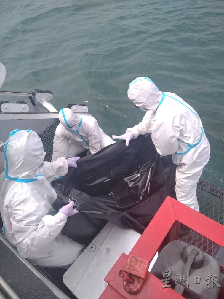 海事执法人员将被发现的尸体移上船。