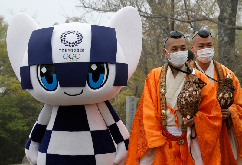 在东京西郊高尾山举行的奥运会徽标展示仪式，有僧侣受邀到现场诵经祈福，祈求东京奥运会顺顺利利开幕，平平安安闭幕。（法新社照片）
