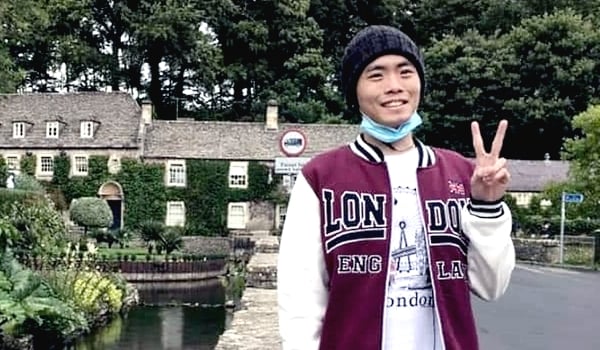 Teoh posing for a picture while studying in the UK.