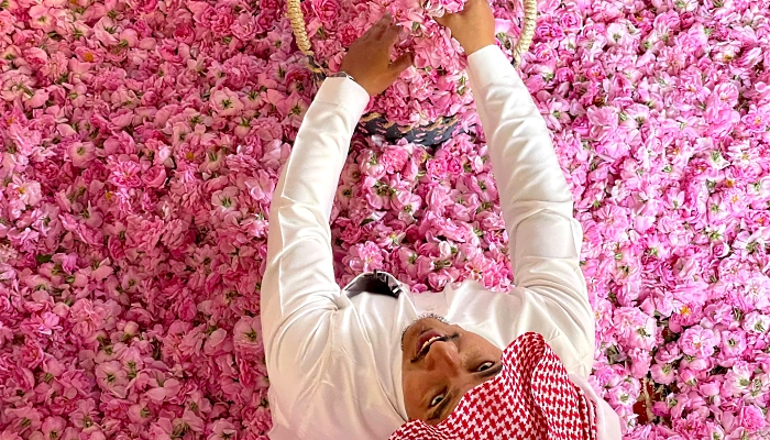 A worker at Bin Salman farm in Taif sits amidst freshly picked Damascena (Damask) roses used to produce rose water and oil. AFP