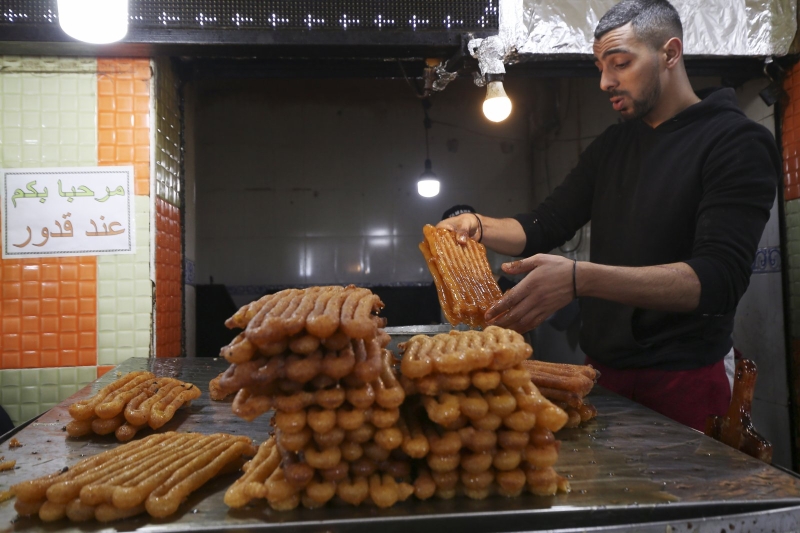 一名男子在阿尔及利亚首都阿尔及尔制作名为“兹拉比亚”的油炸甜点。