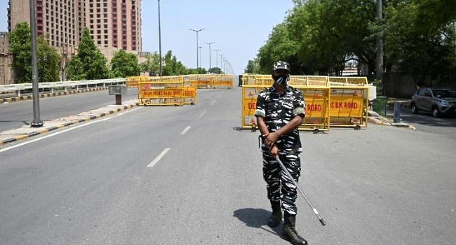 A police officer at a checkpoint during a previous weekend lockdown in New Delhi. AFP