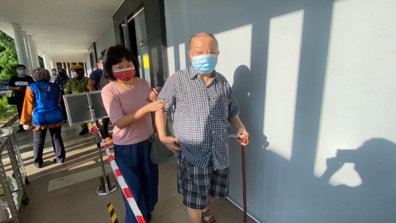 91岁的陈升利（译音）周一早上在家人的陪同下抵达位于威省会展中心的疫苗接种中心。

