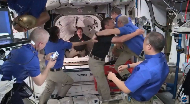 新一批太空人成功进入太空站后，与身处太空站的7名太空人欣喜相拥。（图：法新社）
