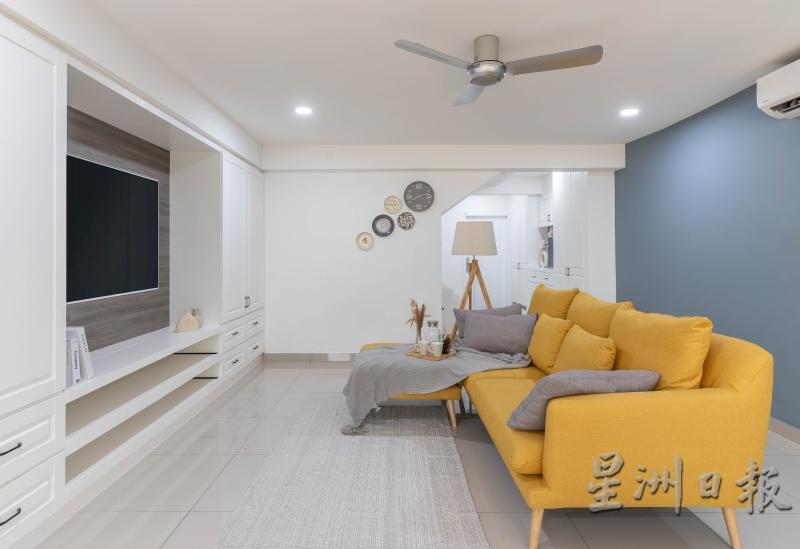 屋子的室内设计以摩登英式为主轴，即白色的橱柜，搭上灰色墙壁及黄色沙发，色彩柔和又惊艳。