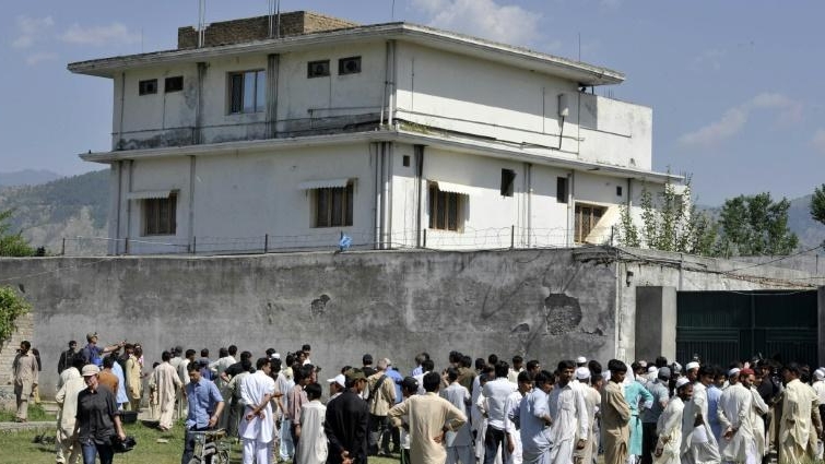 Journalists and local residents gather outside bin Laden's hideout after his death. AFP Journalists and local residents gather outside bin Laden's hideout after his death. AFP