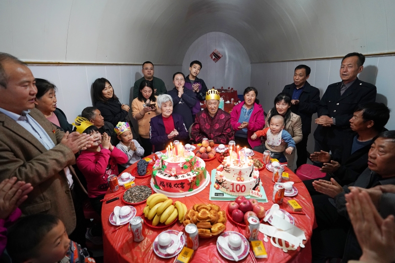胡在忠的家人在生日宴上为老人唱生日歌。（图：新华社）