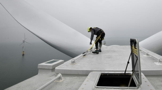 An engineer checks the top of a turbine tower at an offshore wind farm in waters some 10km off Gochang. AFP