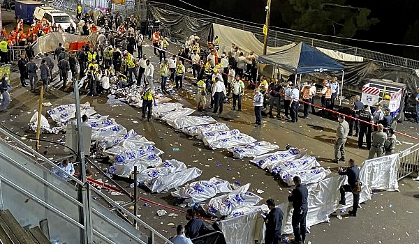 Israeli security forces stand around the bodies of victims who died during a stampede at Mt Meron.