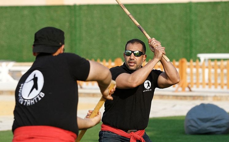 Youths take part in a training session of Egypt's combative sport of 'tahtib' (stick-fighting), in Cairo. AFP