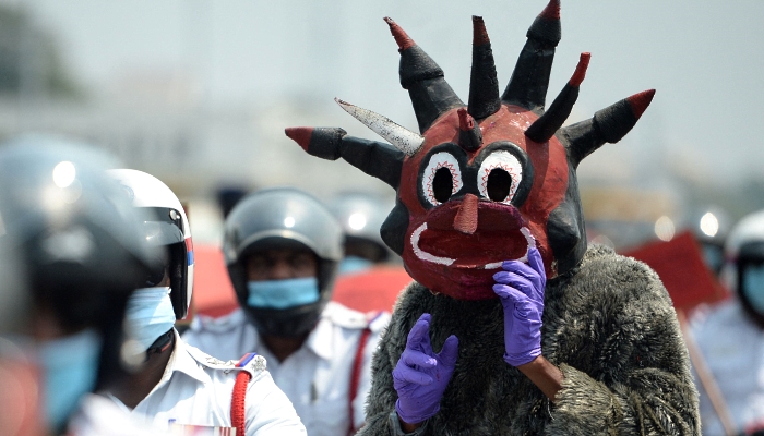 A policeman dressed up as a demon takes part in a coronavirus awareness rally with other policemen in Chennai, India. AFP