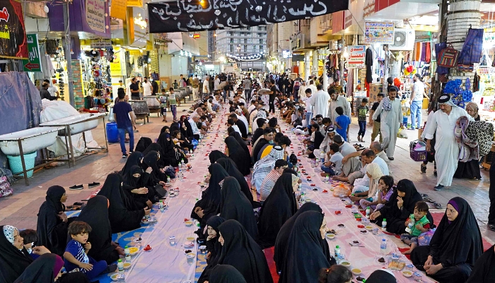 Iraqis gather for an iftar meal offered by local activists in the central shrine city of Najaf about 160km south of Baghdad. AFP