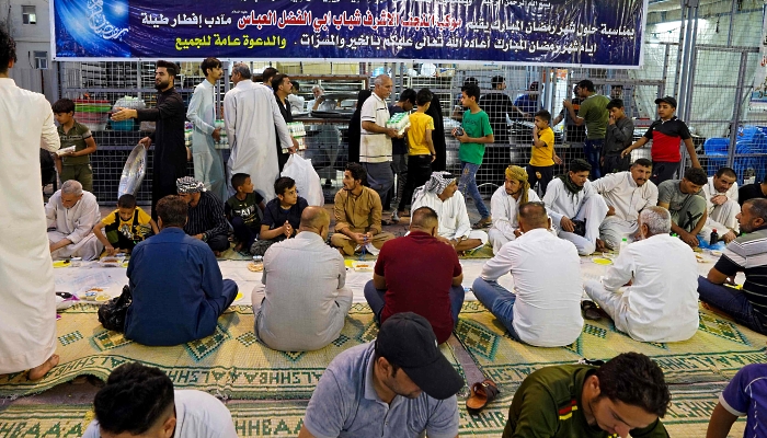 Iraqis gather for an iftar meal offered by local activists in the central shrine city of Najaf about 160km south of Baghdad. AFP
