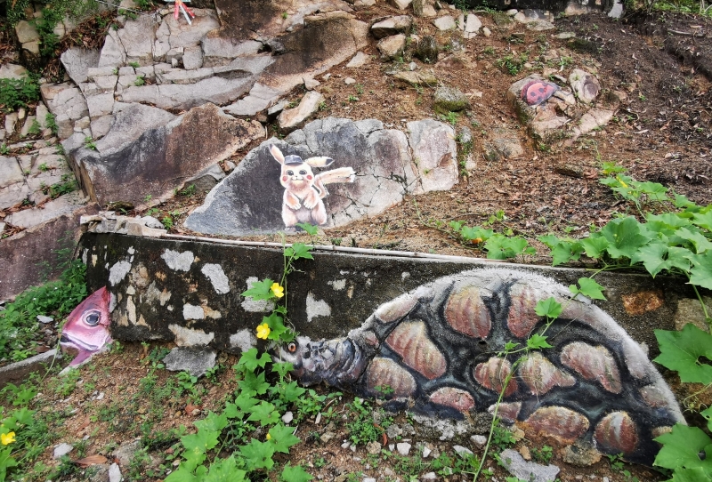 隐藏在挡土墙上的大乌龟、鱼头、皮卡丘及甲虫等壁画。