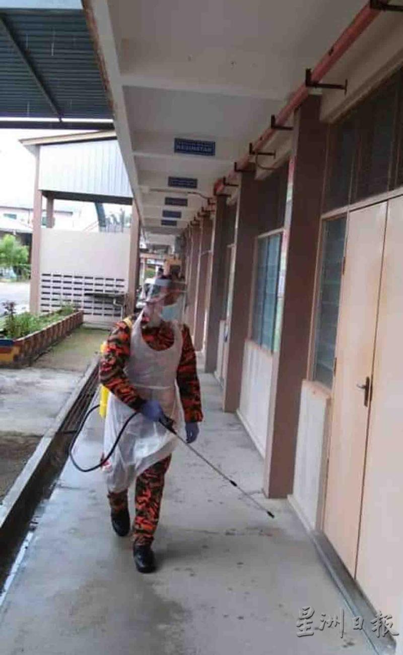 消拯员在学校的走廊进行消毒工作。