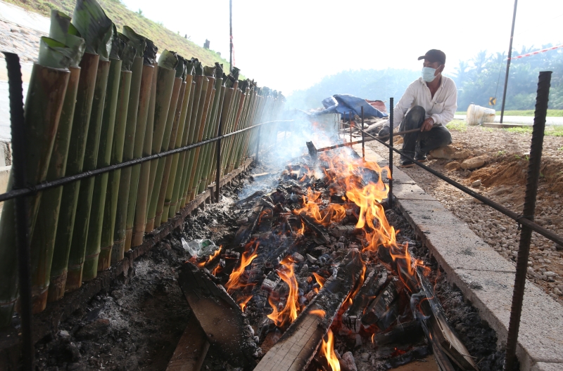 路旁燃起的熊熊火焰，烘烤出香喷喷的竹筒饭。