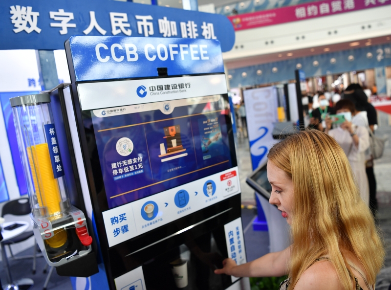 图为一名来自俄罗斯的参观者使用数字人民币咖啡机购买咖啡。（中新社照片）