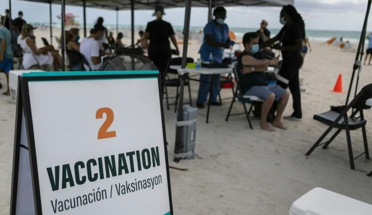People get a Johnson & Johnson Covid-19 vaccine at a pop-up vaccination center at the beach, in South Beach, Florida. AFP