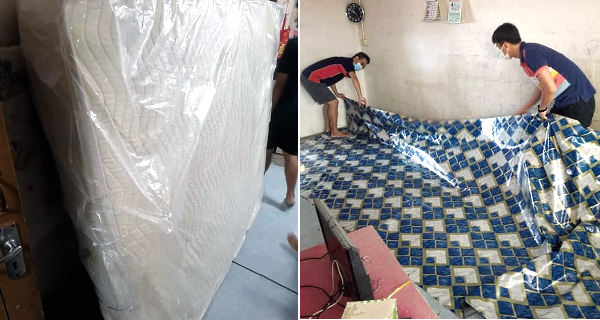 A furniture shop has contributed a mattress to the family; Cheong (L) and his deputy Lock Sin Ho laying the plastic floor mat contributed by a shop. A furniture shop has contributed a mattress to the family; Cheong (L) and his deputy Lock Sin Ho laying the plastic floor mat contributed by a shop.