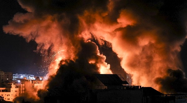 Explosions light up the night sky above buildings in Gaza City as Israeli forces shell the Palestinian enclave, early Tuesday. AFP Explosions light up the night sky above buildings in Gaza City as Israeli forces shell the Palestinian enclave, early Tuesday. AFP