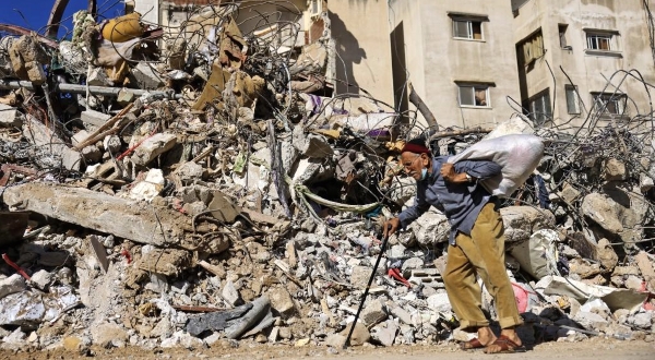 A Palestinian elderly man walks past a building destroyed by Israeli bombardment in Gaza City. AFP A Palestinian elderly man walks past a building destroyed by Israeli bombardment in Gaza City. AFP