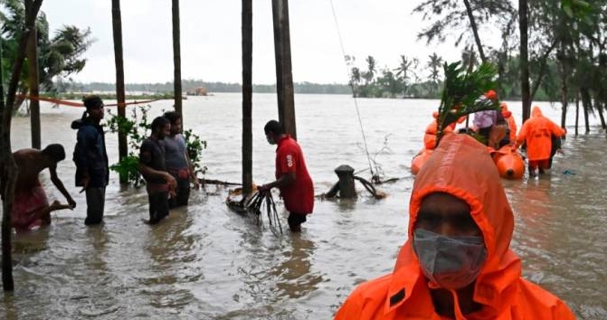 National Disaster Response Force (NDRF) personnel use inflatable boats to ferry stranded villagers through the flood waters after Cyclone Yaas. AFP National Disaster Response Force (NDRF) personnel use inflatable boats to ferry stranded villagers through the flood waters after Cyclone Yaas. AFP
