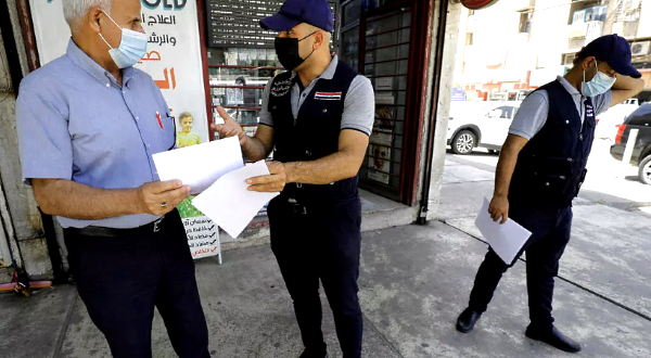 Members of the Iraqi interior ministry's anti-fake news team hand out leaflets in Baghdad. AFP