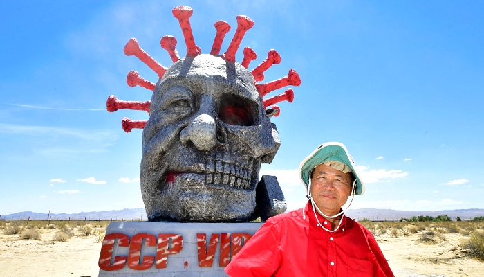Artist and sculptor Chen Weiming poses beside his latest sculpture 