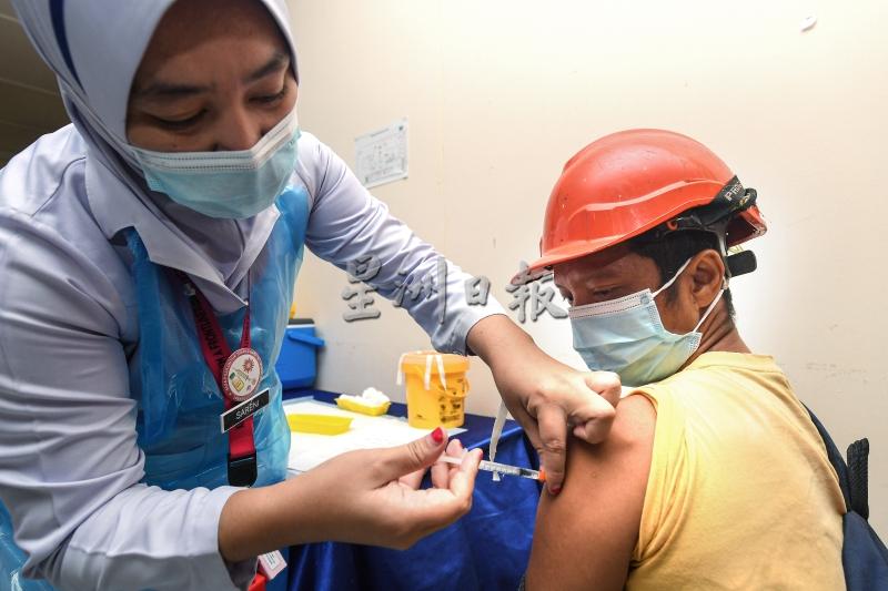 护士为京那巴当岸Kertam油棕园工人立万达末施打疫苗。