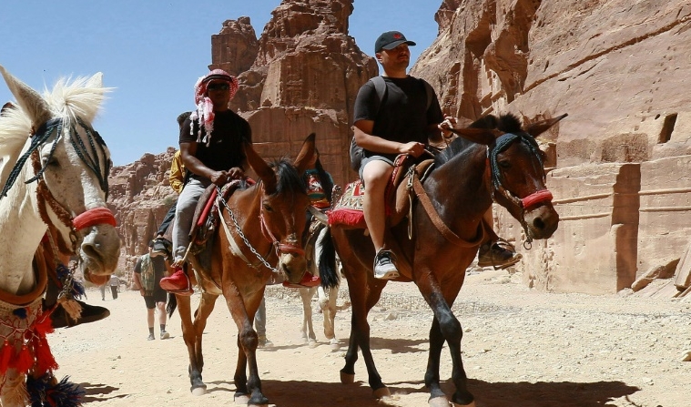 Tourists ride donkeys and horses as they visit Jordan's ancient city of Petra after it reopened following restrictions to stem the coronavirus pandemic. AFP