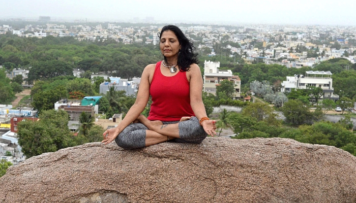 An instructor performs Yoga ahead of the International Yoga Day atop a rock formation at the Gun Rock Hills overlooking the city of Hyderabad in India. AFP